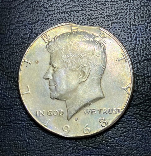1968-S Kennedy half dollar wrong planchet error showing compressed design struck on a smaller quarter planchet compared to normal size